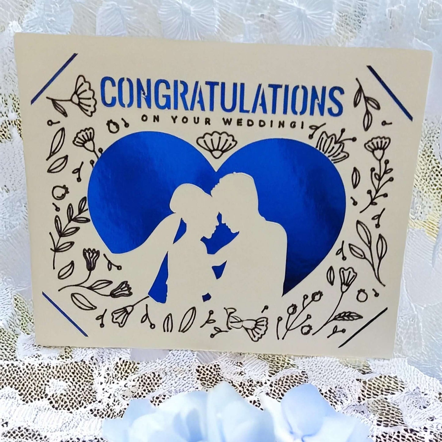 Handmade wedding congratulations card with blue heart and floral design, featuring a romantic silhouette.
