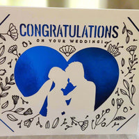 Handmade wedding congratulations card featuring blue heart, floral design, and couple silhouette.