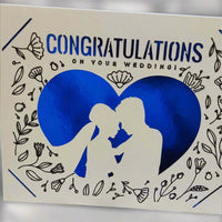 Handmade wedding congratulations card with blue heart and floral design featuring a couple silhouette.