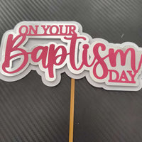 Personalised baptism cake topper with pink script saying 'On Your Baptism Day' for Christening decorations.