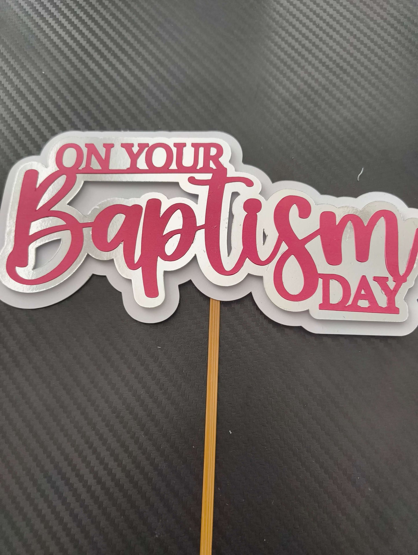 Personalised baptism cake topper with pink script saying 'On Your Baptism Day' for Christening decorations.