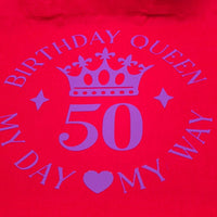 Close-up of red tote bag showing purple crown and number 50 with birthday queen slogan.