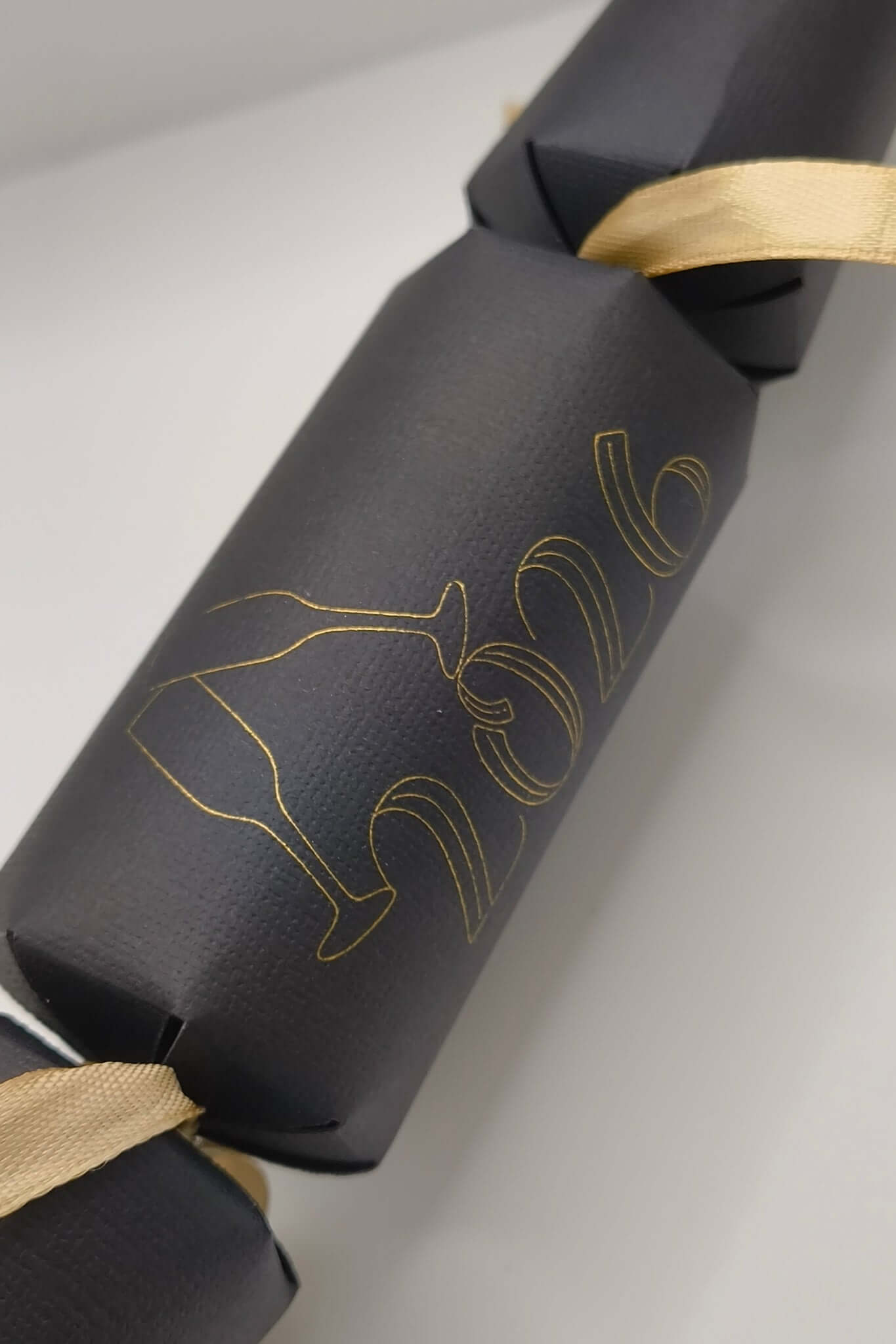 Personalised New Year cracker in black with gold 2016 design and ribbon, perfect for New Year's 2026 celebration.
