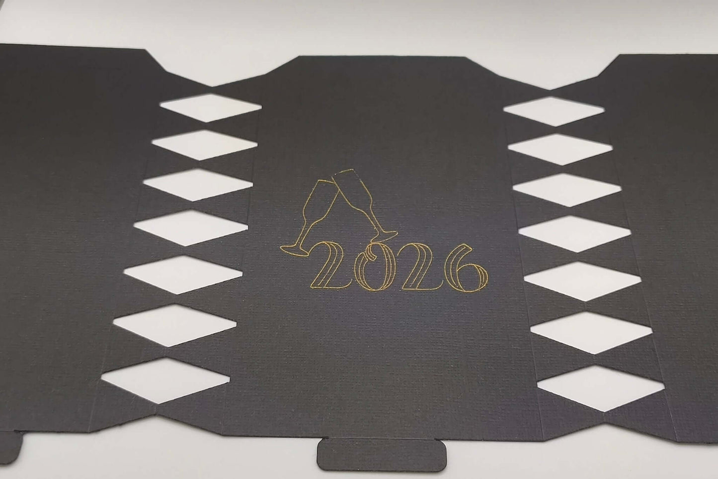 Personalised New Year cracker design featuring 2026 in gold with champagne glasses decoration.