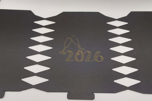 Personalised New Year cracker design featuring 2026 in gold with champagne glasses decoration.