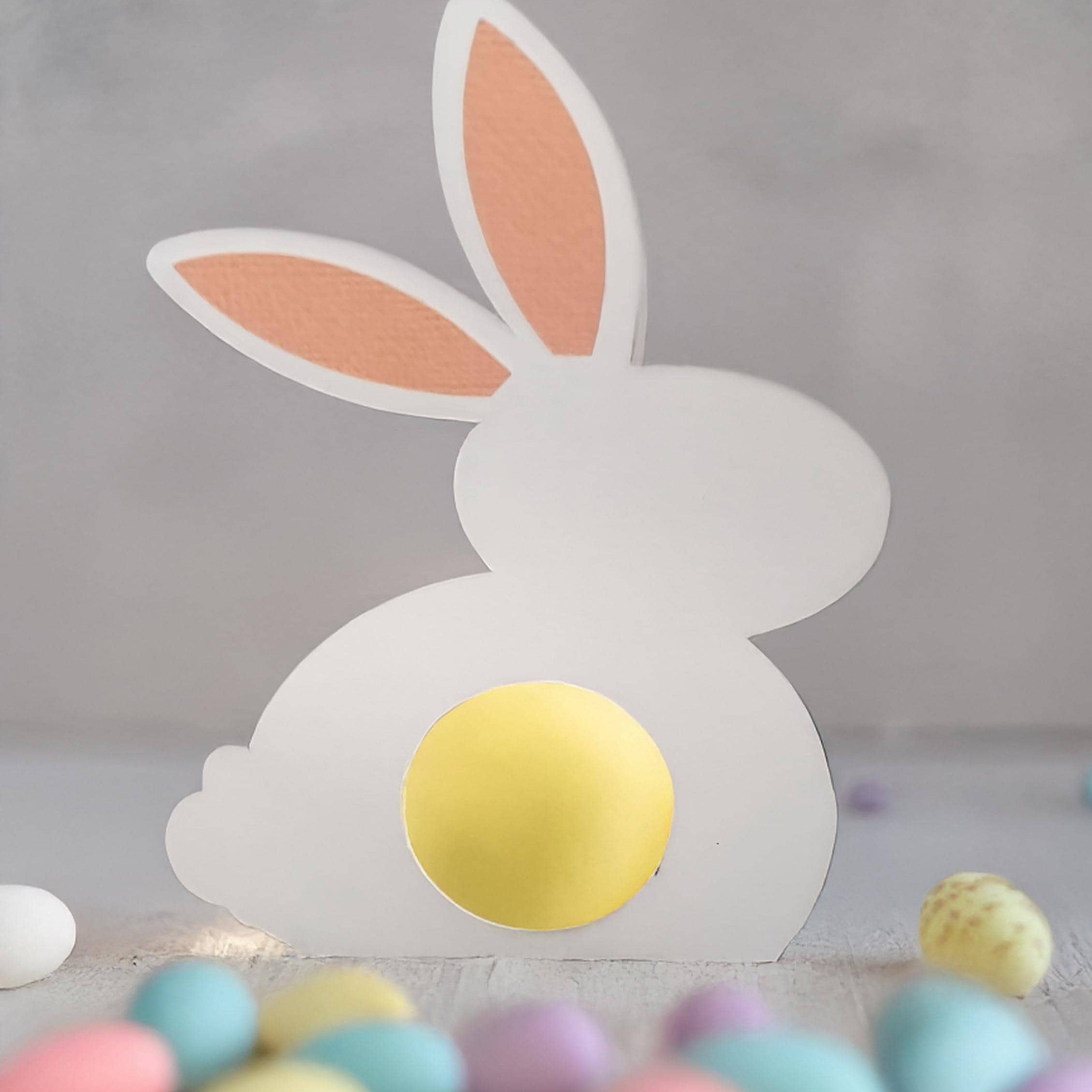 White Easter Bunny Chocolate Holder made of cardstock with personalized gold foil detail on the ear, designed to hold mini chocolate eggs or sweets.