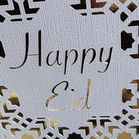 Happy Eid Card featuring intricate laser cut Islamic geometric design in gold and white.