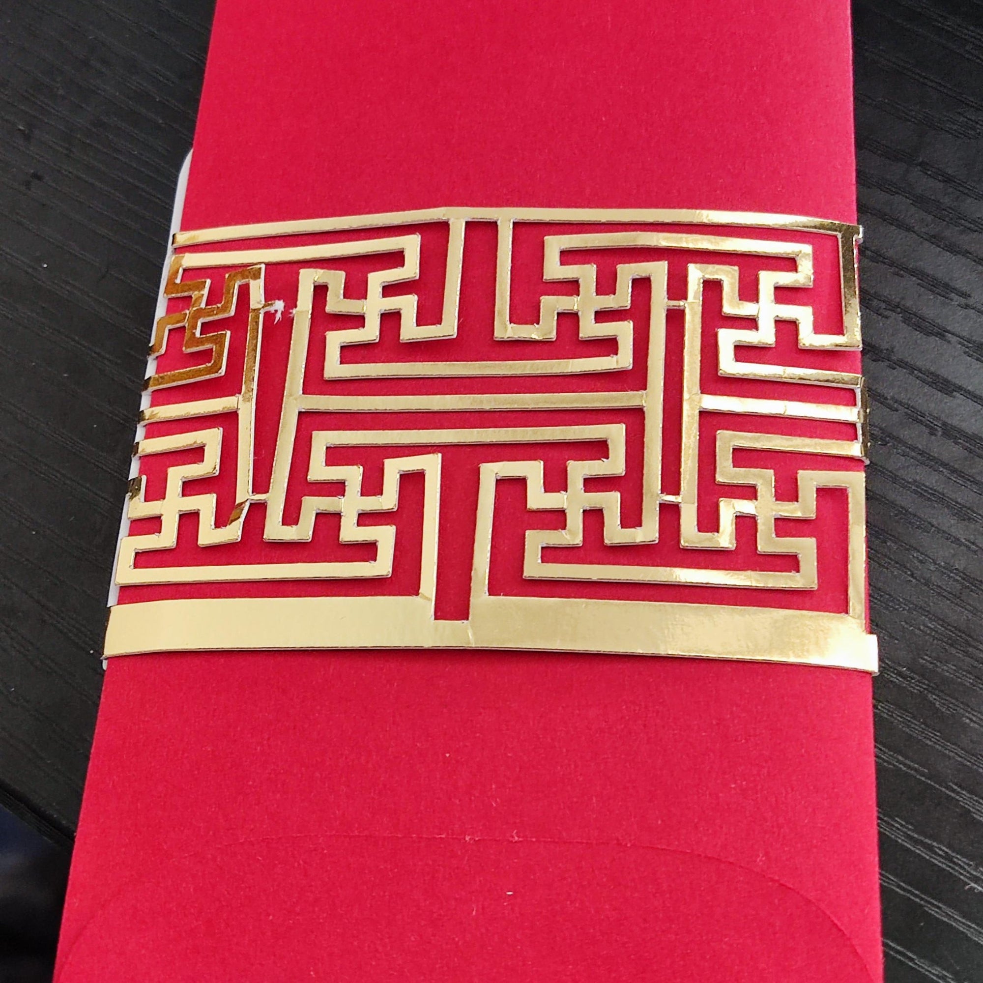 Elegant red envelope with intricate gold geometric pattern for Chinese New Year gift money