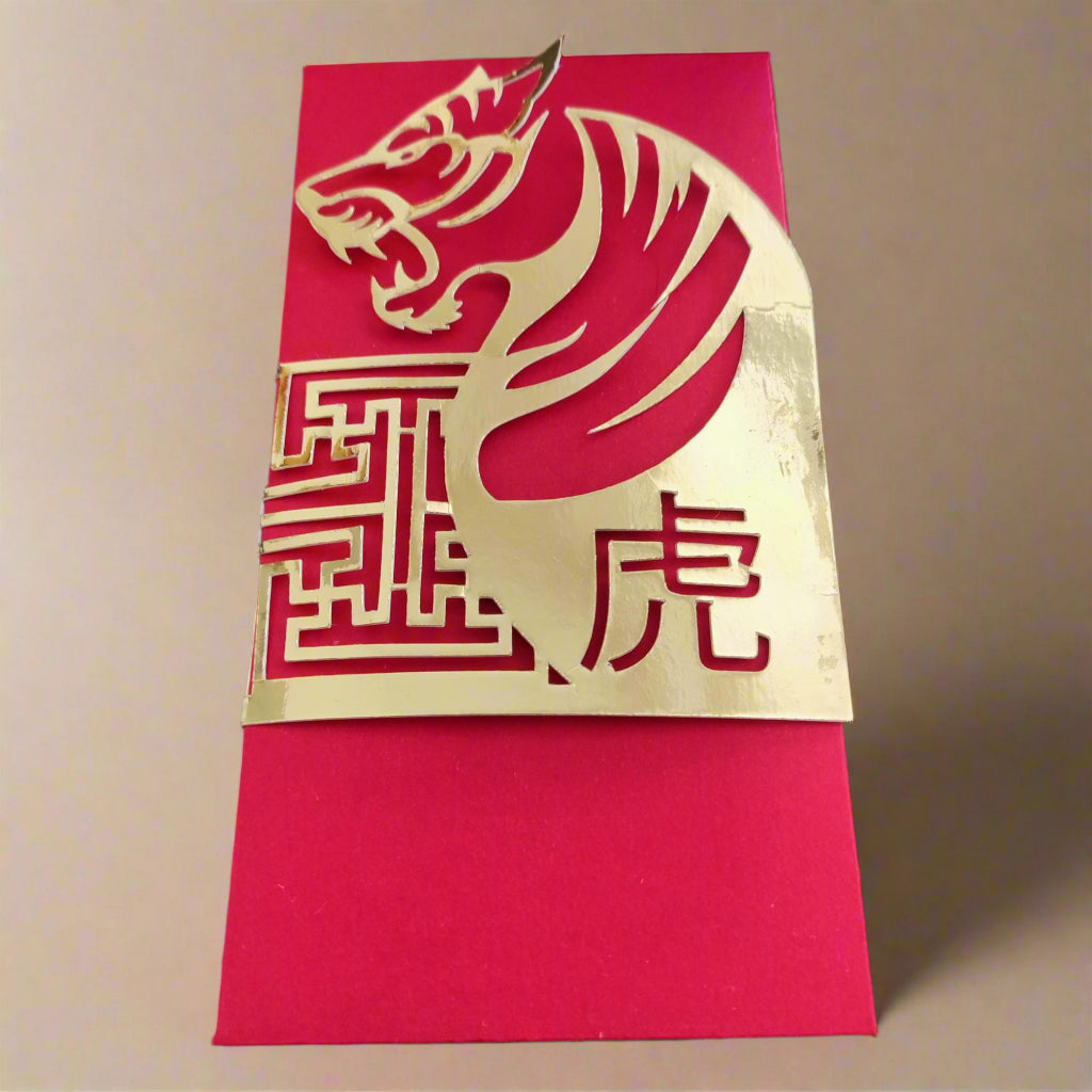 Red and gold Chinese New Year envelope with laser-cut tiger design and intricate gold pattern