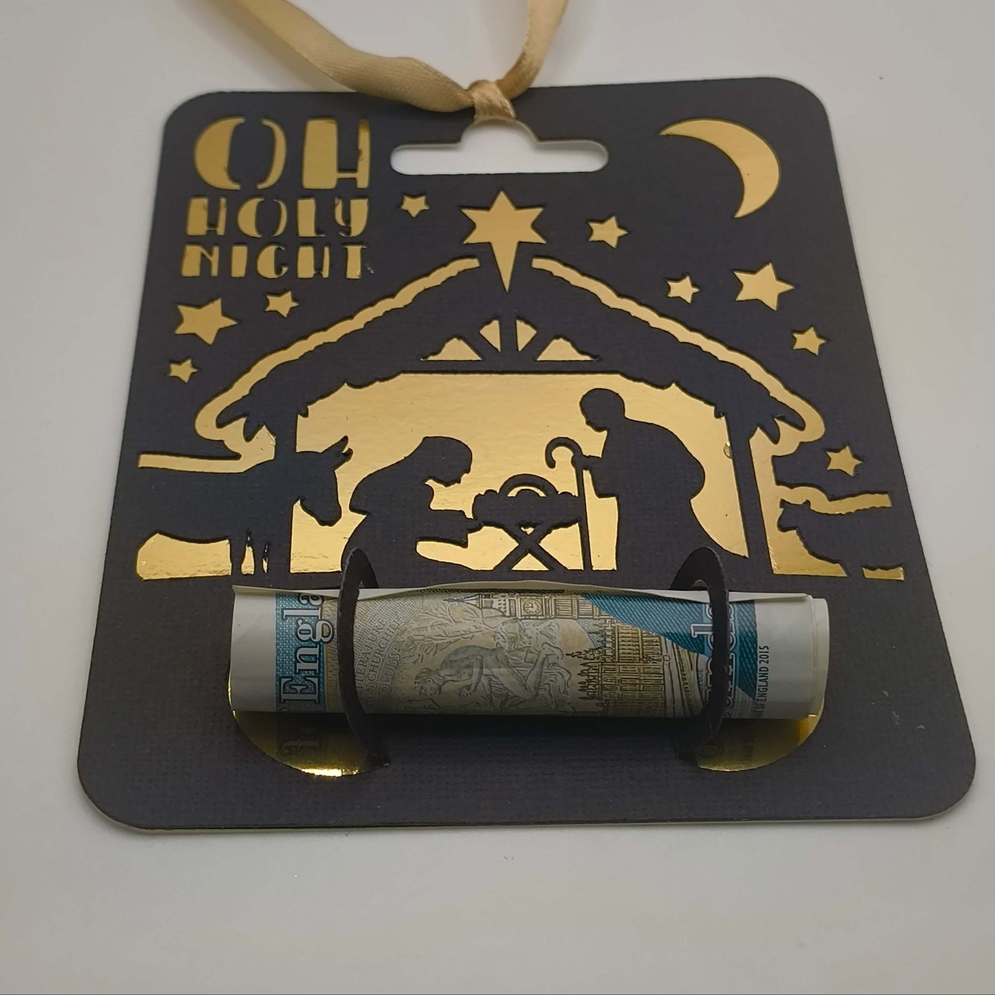 Religious Christmas money holder card featuring gold foil nativity scene and satin ribbon.