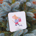 Personalised Christmas mouse coaster with a mouse holding a gift, customized with the name Craig.