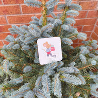 Personalised Christmas mouse coaster with the name Craig, displayed on a Christmas tree branch.