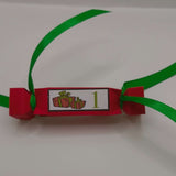 Red handmade Christmas cracker with green ribbon and number 1 gift design label