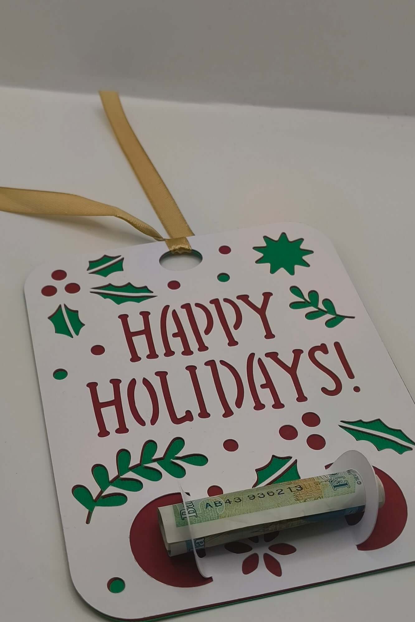 Christmas Happy Holidays card with gold ribbon and money holder slot for gifting.