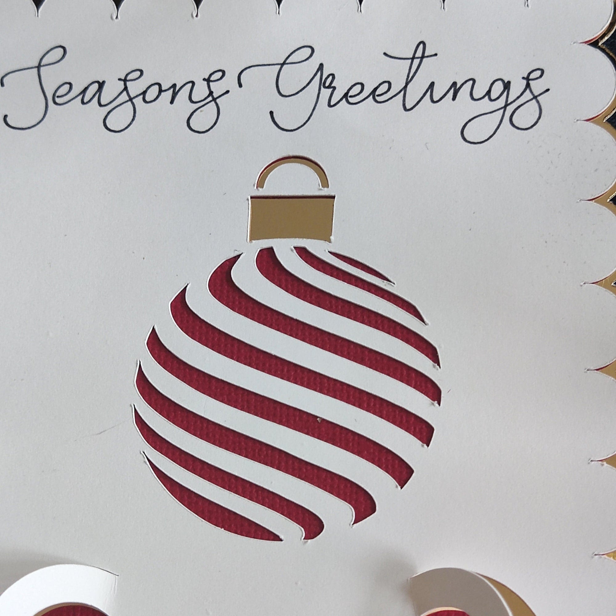 Christmas Money Holder Card with festive cut-out bauble design, gold foil accents, and "Seasons Greetings" text, handmade holiday cash gift envelope