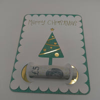 Handmade Christmas money holder card with green glitter border and gold foil Christmas tree, holding a £5 note.