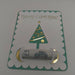 Handmade Christmas money holder card with green glitter border and gold foil Christmas tree, holding a £5 note.