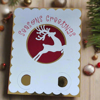 Handmade Christmas money holder card with festive reindeer cut-out and gold foil accents, seasonal greetings design.
