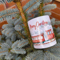Close up of Christmas train mug with snowy winter illustration on pine tree