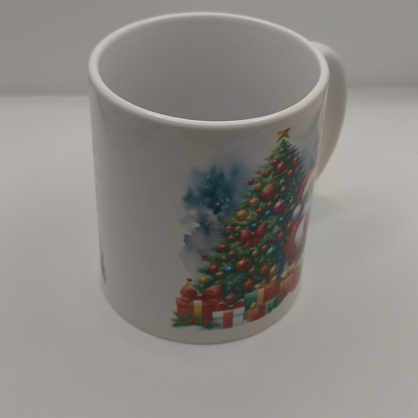 White festive mug with Christmas tree and gift illustration, plain background view