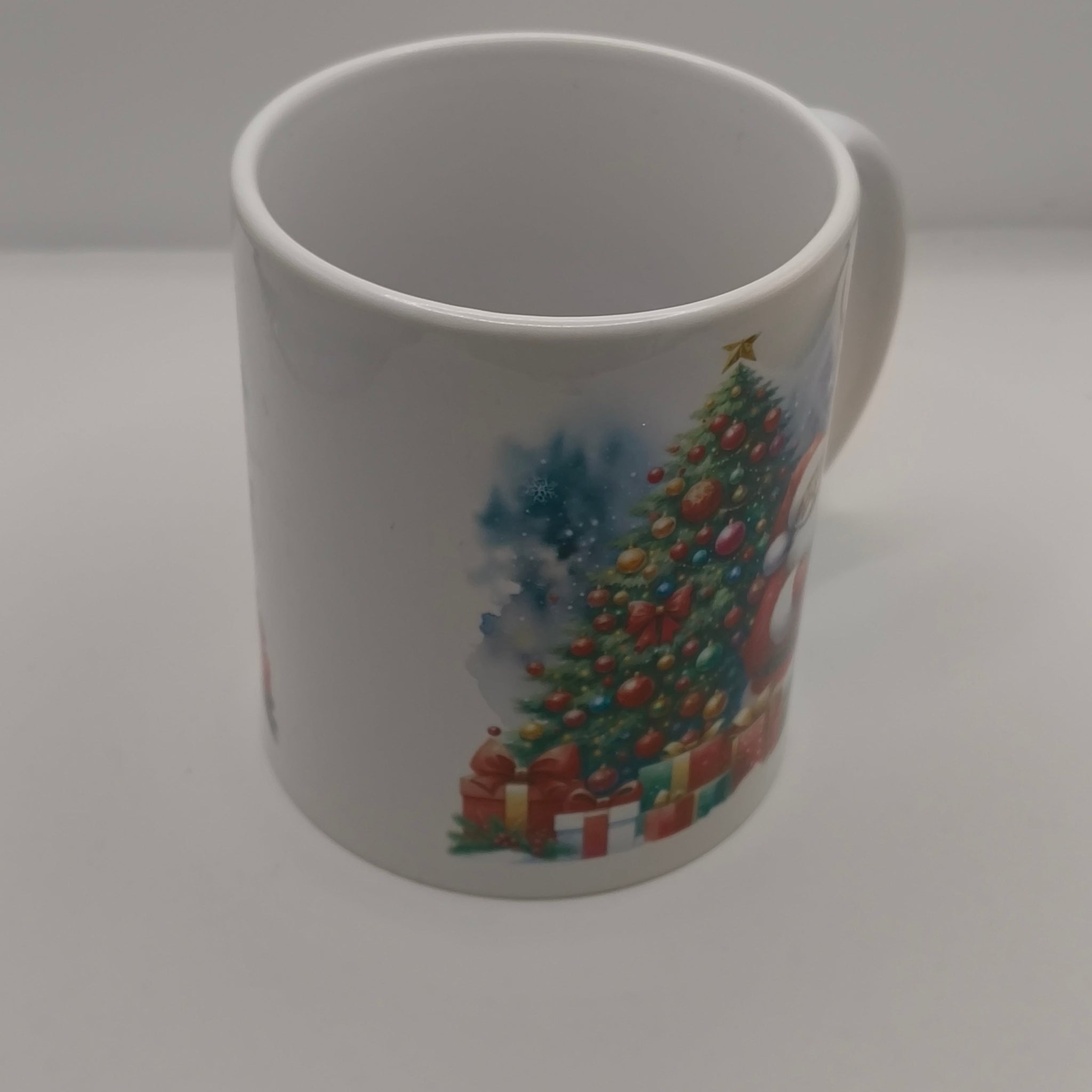 White festive mug with Christmas tree and gift illustration, plain background view
