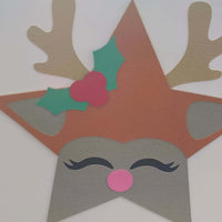 Handmade reindeer Christmas card featuring antlers, holly, and a pink nose in a star shape.