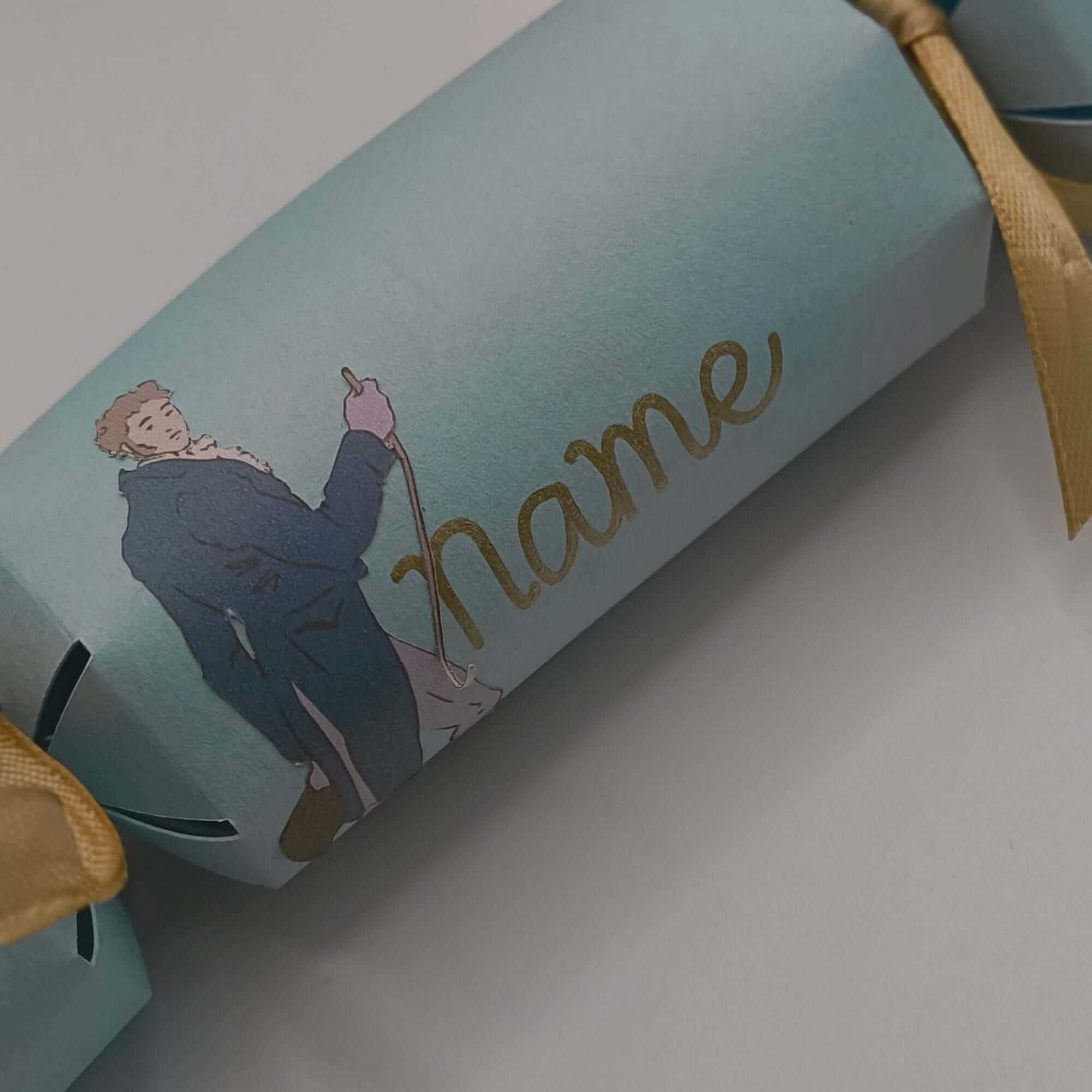 Personalised Regency style cracker with gold lettering and illustration of a gentleman, perfect for table settings.