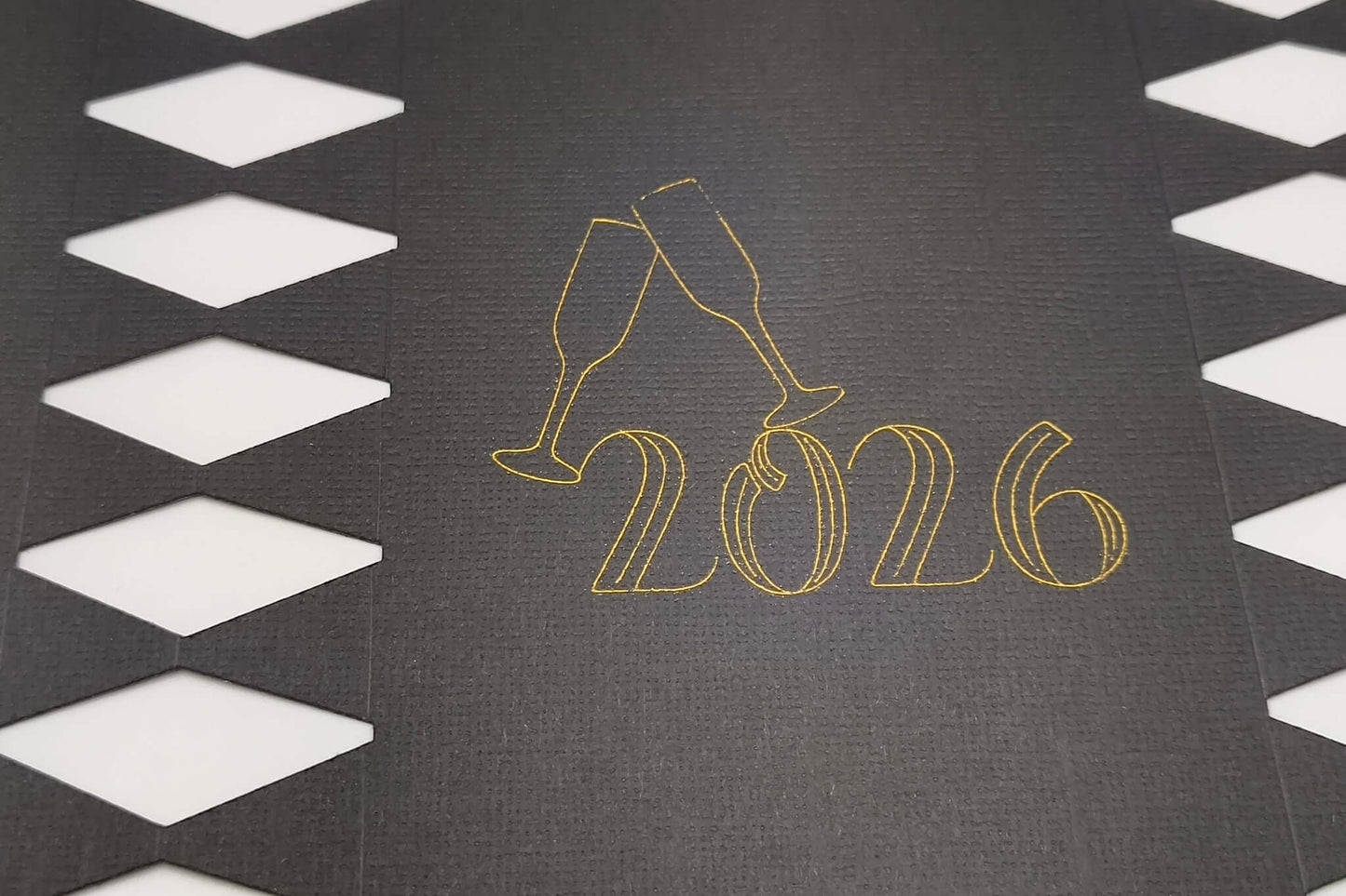 Personalised New Year cracker design featuring 2026 with champagne glasses on a black background.