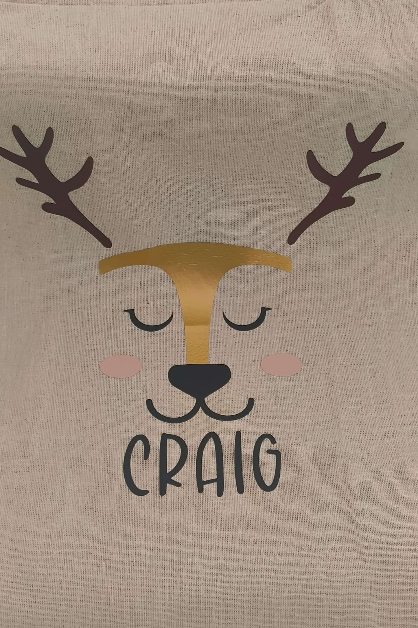 Personalised reindeer gift sack featuring a cute reindeer face and the name 'Craig' in bold black letters.
