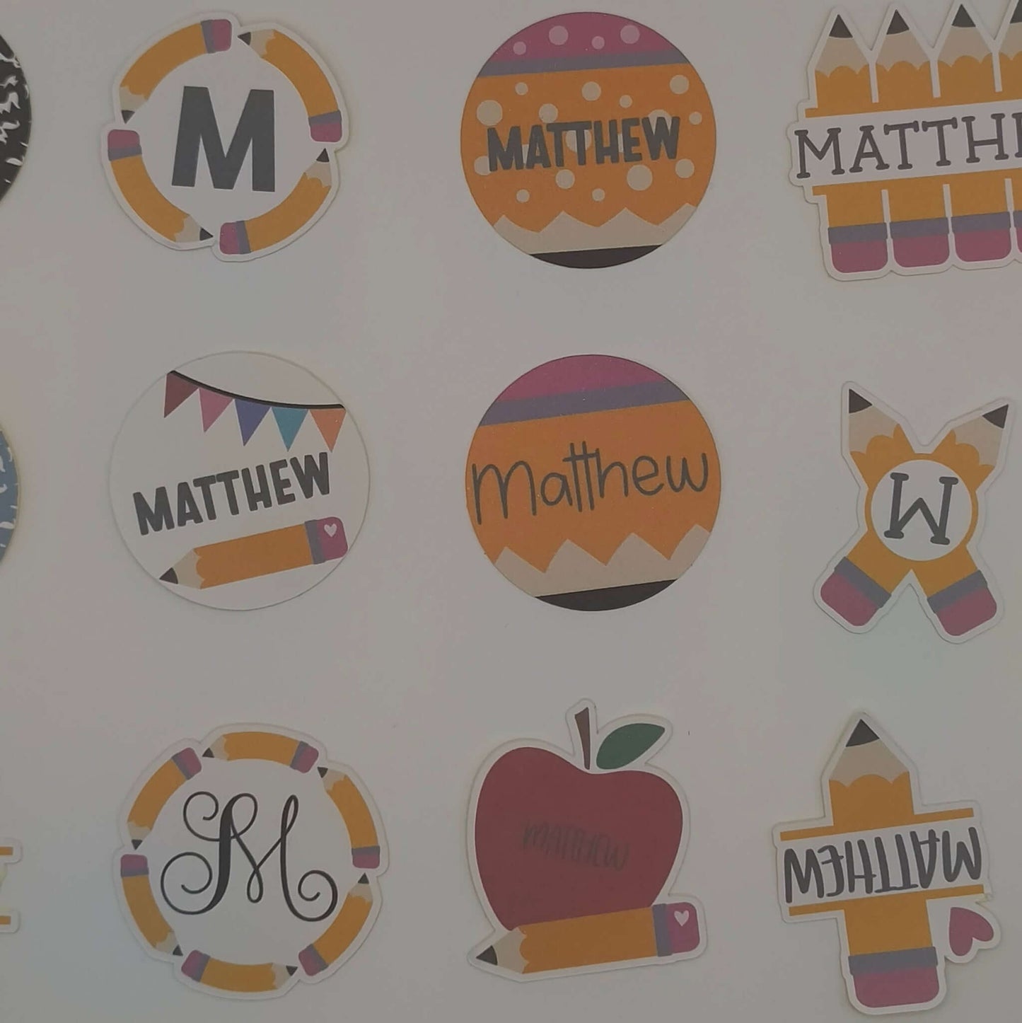 Personalised school name stickers featuring playful designs and the name Matthew in various styles.