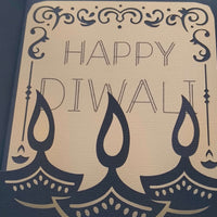 Handmade Diwali card featuring intricate design with the text 'Happy Diwali' and decorative oil lamps.