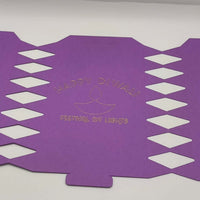 Purple cracker design unfolded flat with cut-out diamonds and gold foiled “Happy Diwali Festival of Lights” message at centre.