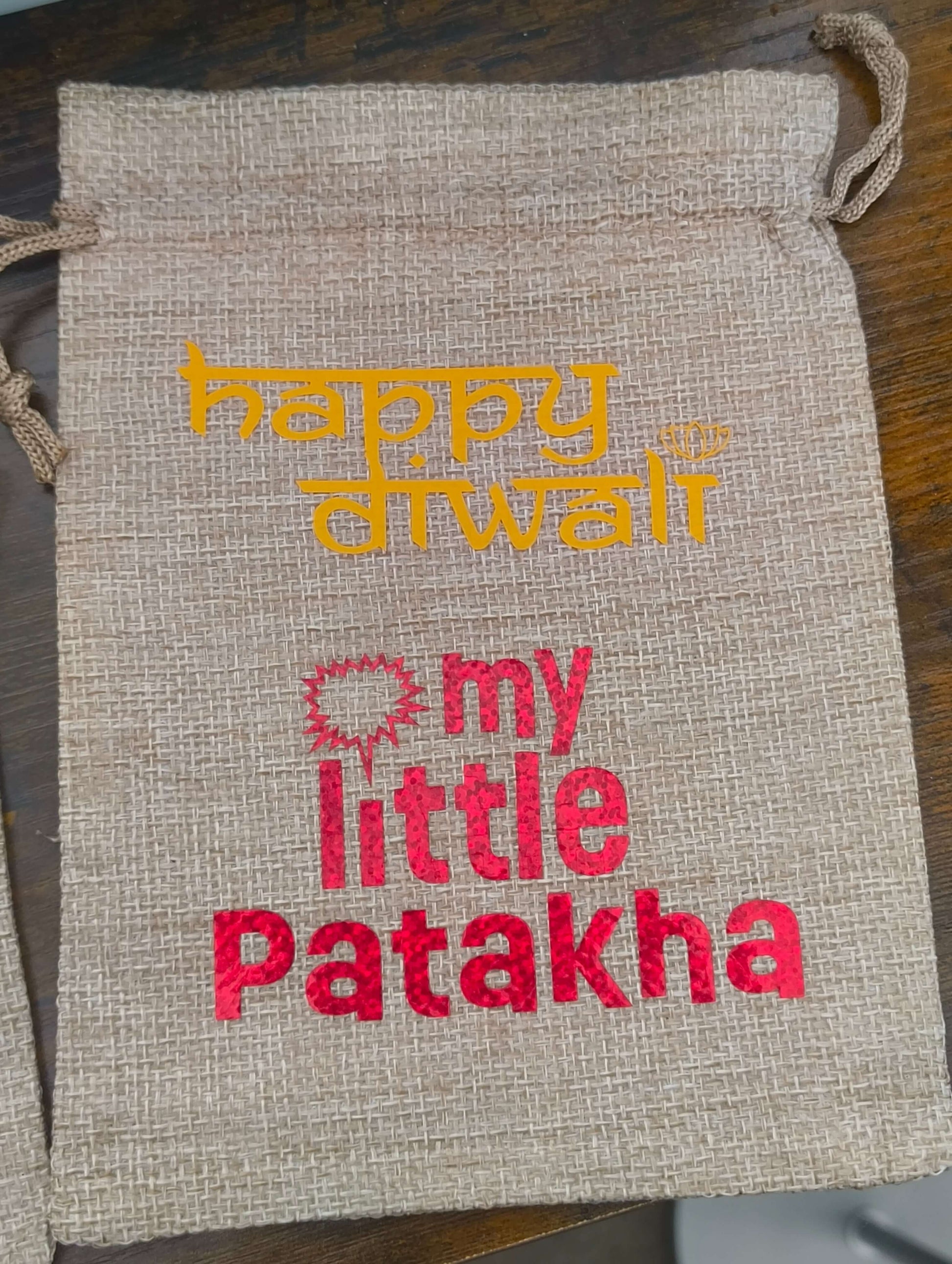 Personalised hessian Diwali gift bag with text 'Happy Diwali' and 'my little Patakha' in vibrant colors.