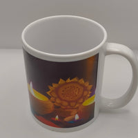 Side view of white ceramic Diwali mug decorated with colourful oil lamps and a radiant golden mandala motif, captured against a bright studio backdrop.