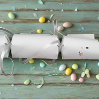 Handmade Easter Bunny cracker in white cardstock with silver ribbon ties, designed for filling with sweets or gifts, perfect for Easter celebrations.