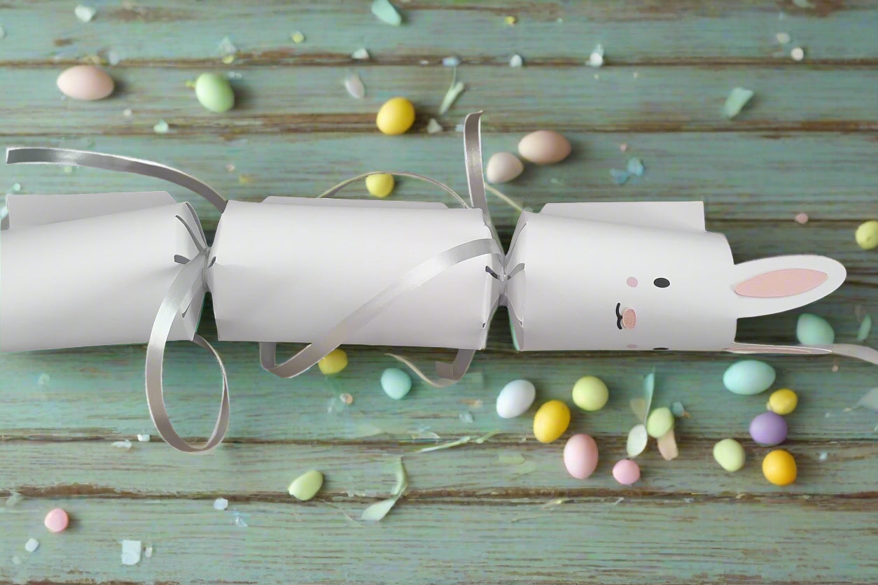 Handmade Easter Bunny cracker in white cardstock with silver ribbon ties, designed for filling with sweets or gifts, perfect for Easter celebrations.