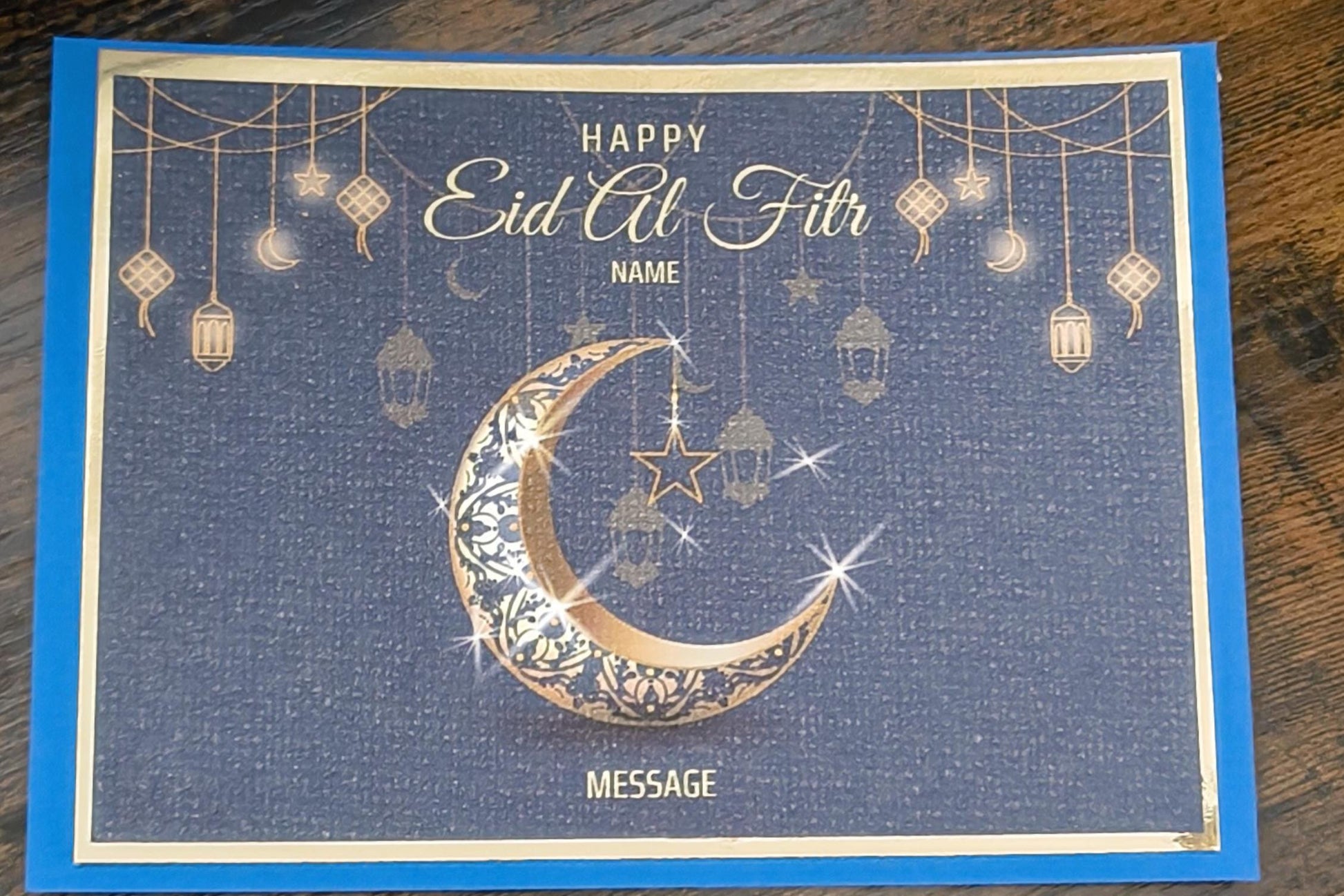 Personalised Eid al-Fitr card with gold crescent moon and lanterns on a navy background, space for custom name and message.