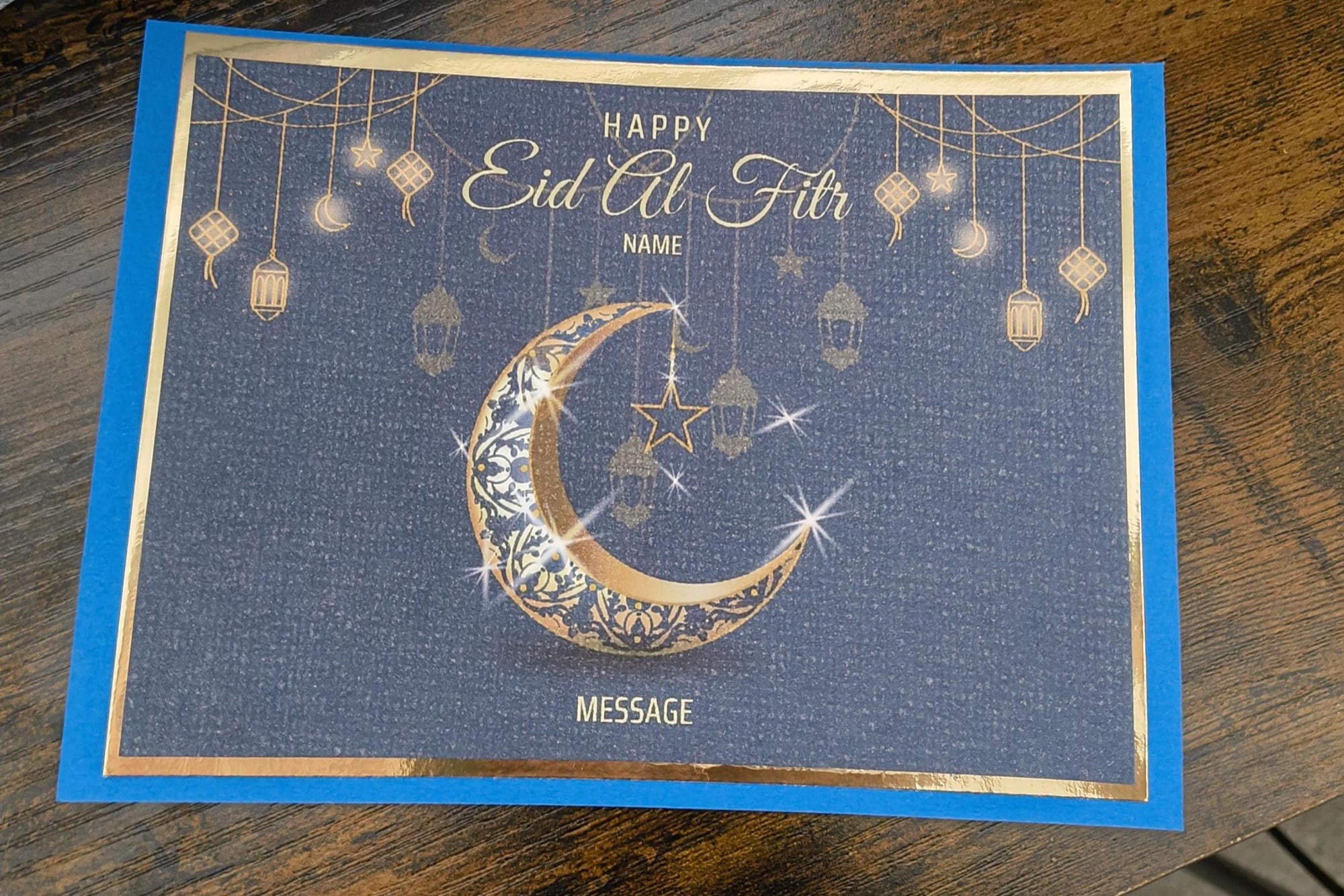 Elegant navy and gold Eid al-Fitr greeting card featuring crescent moon, lanterns, and editable name and message sections.