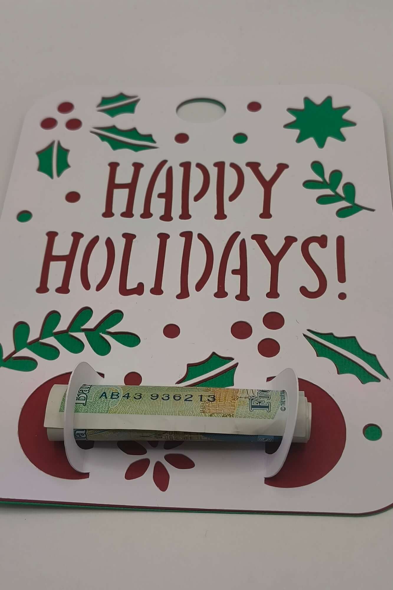 Festive money holder card with Happy Holidays message and rolled note gift inside.