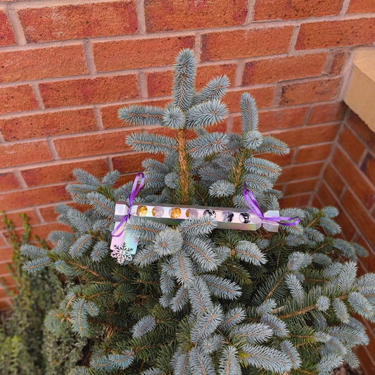 Personalised chocolate cracker gift displayed on a festive tree for Christmas celebration.
