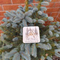 First Christmas New Home Coaster placed on a Christmas tree, celebrating a new home during the holiday season.