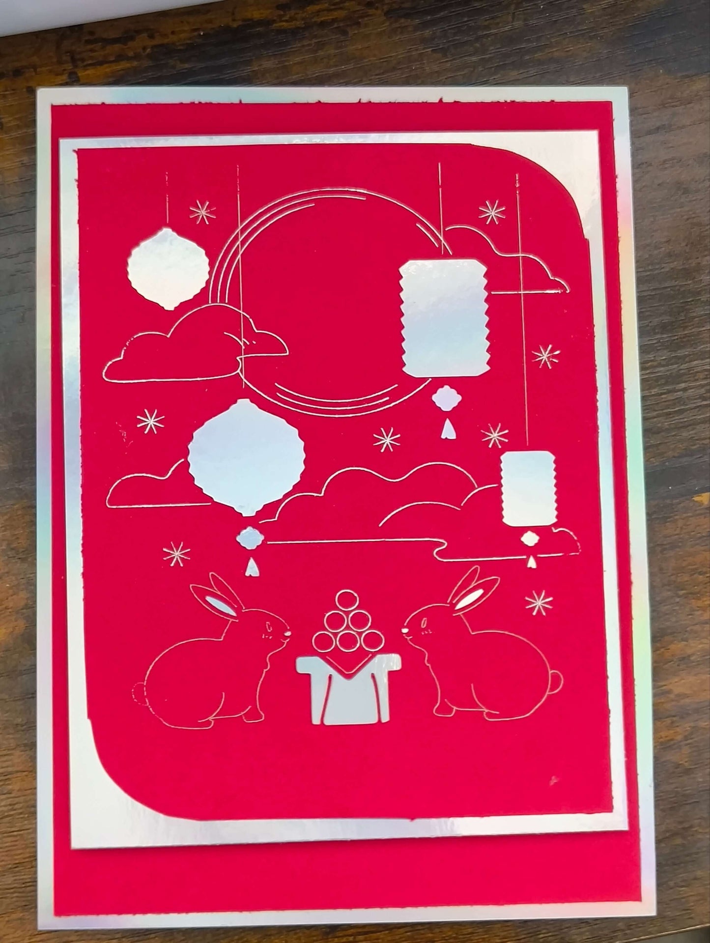 Handmade Mid-Autumn Festival card featuring red foil, moon rabbits, and floating lanterns on vibrant cardstock.