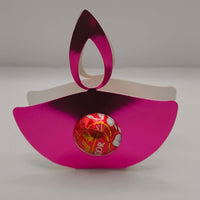 Pink metallic Diwali diya favour for sweets or gifts, featuring a shiny design with a chocolate inside.