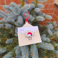 Festive handmade gift card holder envelope with red Santa hat cow design on Christmas tree