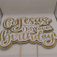 Gold and white “Go Jesus It’s Your Birthday” cake topper with wooden sticks, handmade religious party decoration.