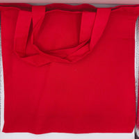 Plain back of red cotton tote bag, showing sturdy handles and quality stitching, reusable eco-friendly fabric.