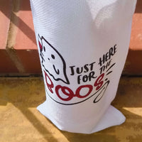 Close-up of Halloween wine bag with ghost and glitter red "BOOS" text, showing textured white fabric and bold design.
