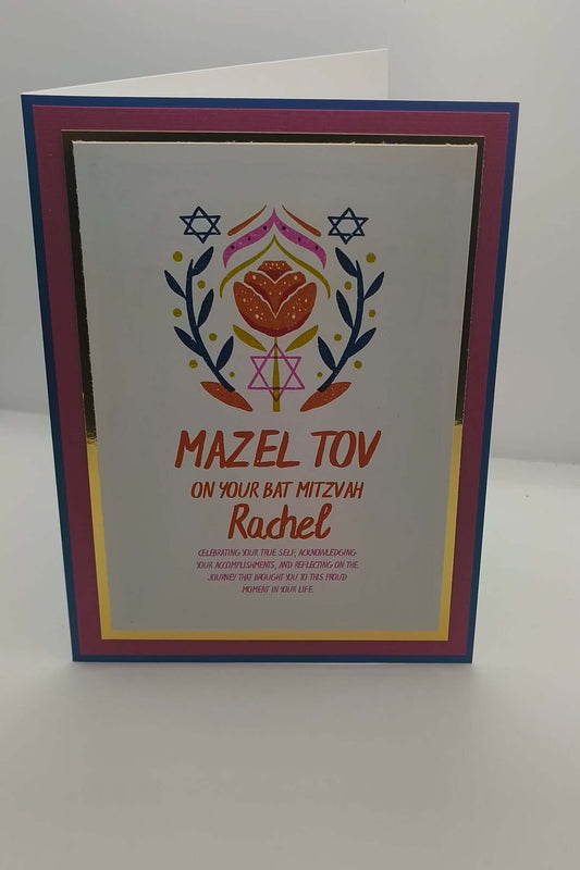 Standing Bat Mitzvah greeting card featuring Mazel Tov message, floral Star of David illustration, and personalised name Rachel, with layered cardstock in blue, pink, and gold.