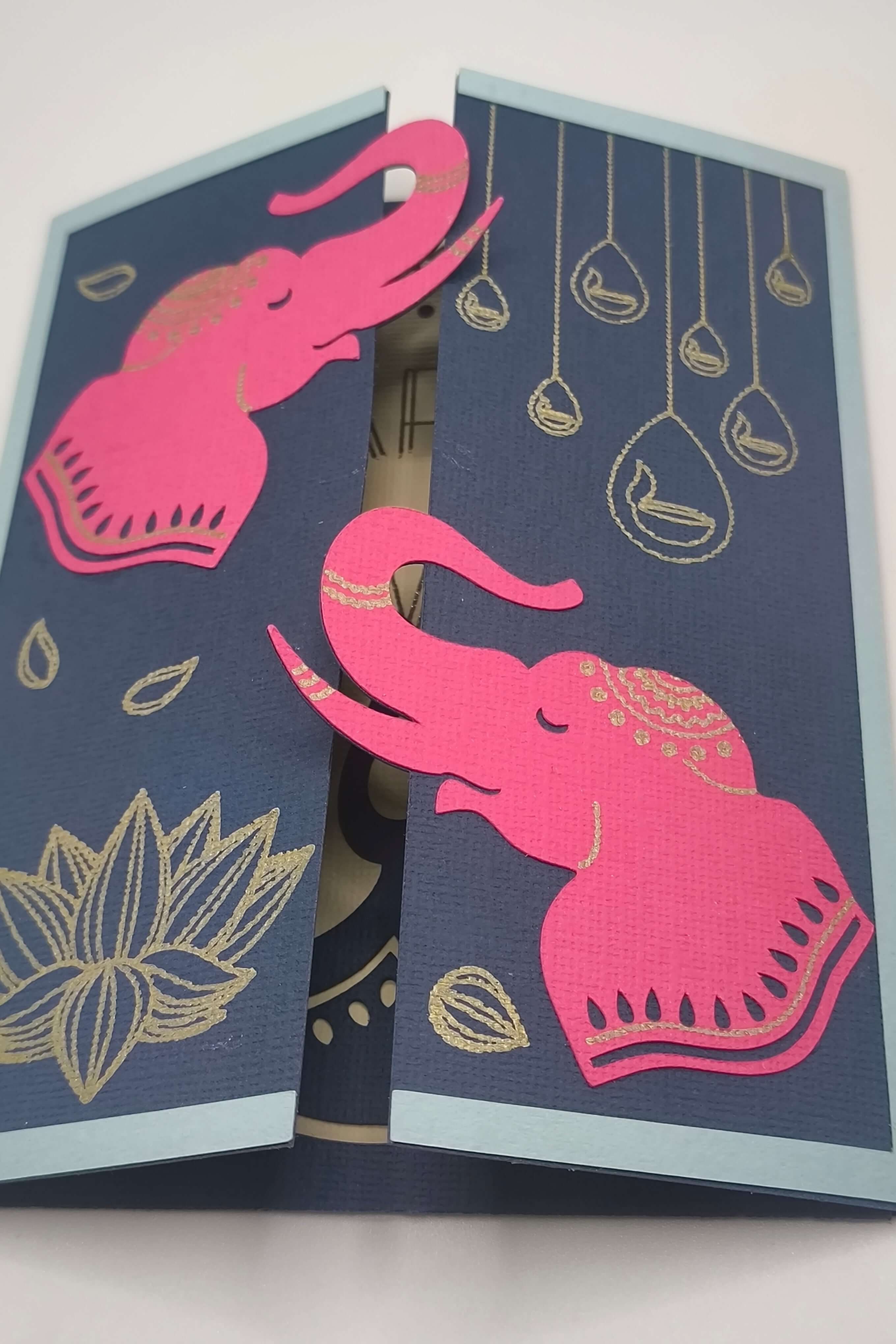 Handmade Diwali Card featuring pink elephants on navy background with gold elements, perfect for celebrations.