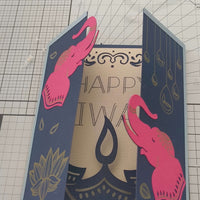 Handmade navy and gold Diwali card featuring pink elephant decorations and intricate design elements.